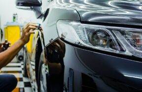 “Detailing expert applying ceramic coating in Noida studio”